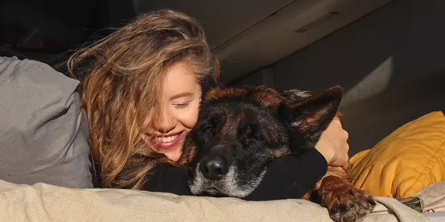 Girl with dog on rear bed in California 600